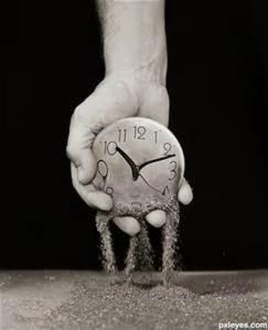 An image where a clock is made of sand and is dissolving with time.
